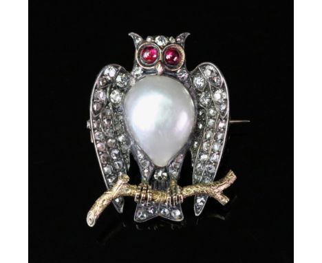 A late 19th/early 20th century diamond, pearl and ruby owl brooch, realistically formed, the body centred with a tear shaped 