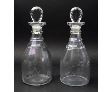 A pair of George III glass maul shape decanters, with stepped necks and faceted stoppers, each engraved 'Lodge of Unity 411' 