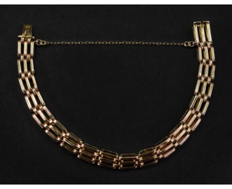 A 14ct rose gold gate-link bracelet with box and tongue clasp and trace-link safety chain, 12.4g gross.