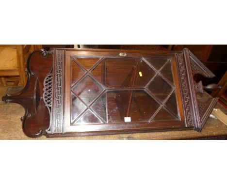 A circa 1900 mahogany single astragal glazed door hanging corner cupboard, in the Chippendale Revival taste