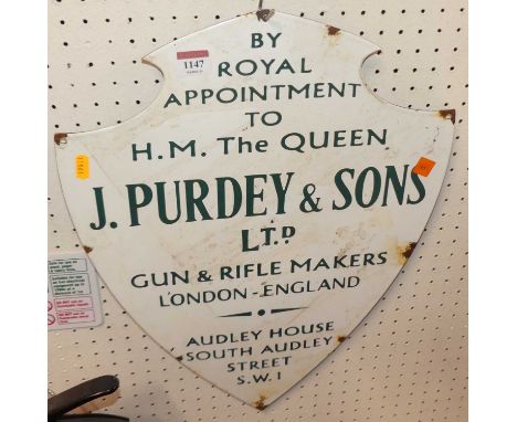 An enamel on metal wall mounted shield shaped sign, 51 x 39cm