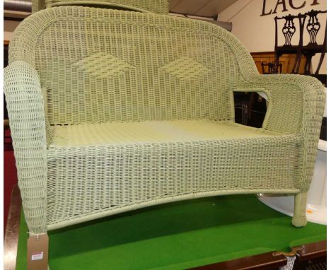 A contemporary faux wicker lime green coloured conservatory suite, comprising; two-seater sofa, pair of armchairs, and a low 