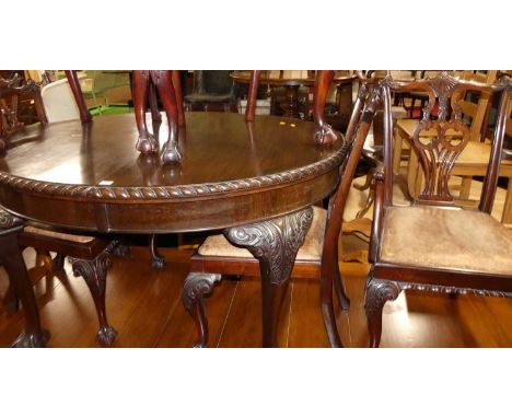 An early 20th century mahogany dining suite in the Chippendale style, comprising; D-end extending dining table with wind-out 