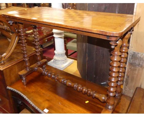 A Victorian walnut and chess board topped inlaid round cornered games table, raised on bobbin turned twin end supports, width