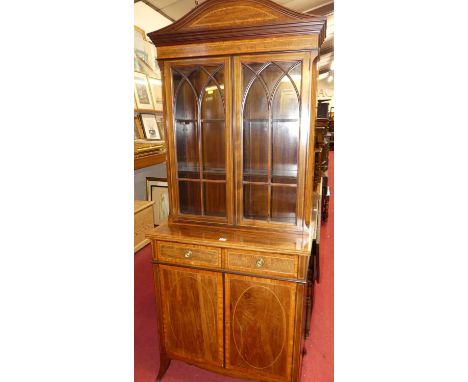 A good circa 1900 mahogany and satinwood inlaid bookcase cupboard, having twin glazed upper doors enclosing twin shelved inte