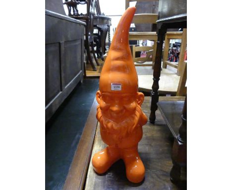 A contemporary orange painted fibreglass model of a garden gnome, h.60cm