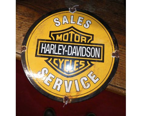 An enamel on metal circular wall sign inscribed 'Harley Davidson Motorcycles', dia,. 30cm