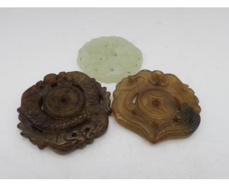 Carved jade circular panel decorated with a dragon and bird D4.6cm, and two carved jade pendants decorated with dragons D5.5c