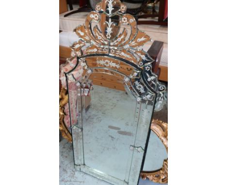 Venetian style wall mirror, segmented arched plate decorated with foliage, and with pierced urn and scroll cresting H.120cm W