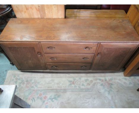 Ercol golden elm side board, three drawers enclosed by two doors with oval handles W155cm D43cm H68cm 