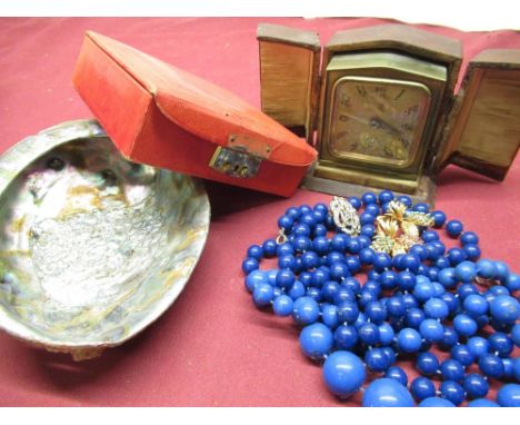 Two simulated lapis lazuli beaded necklaces, leather jewellery box and an early 20th C travelling alarm clock in fitted case 