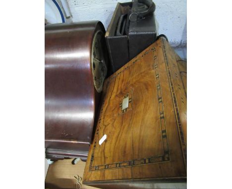 1930s mantle clock, arched mahogany case raised on squat ball and claw feet, oval silver dial with applied Arabic numerals th