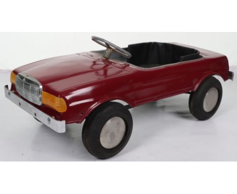 A Mercedes 500SEC Sports pressed metal child’s pedal car, probably English 1970s, painted in maroon with black upholstered se