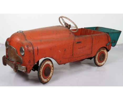 A scarce Tri-ang Commercial pressed steel child’s pedal Tipper Truck, English 1950s, red painted body, cast steering wheel wi
