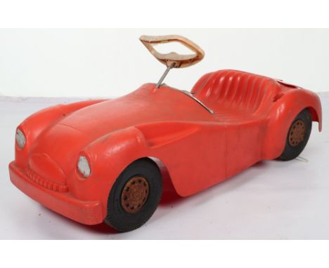 A Marx moulded plastic Triumph TR2 child’s sit on push-along Sports car, circa 1970, finished in red with steering wheel, det