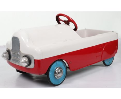 A Tri-ang pressed steel Monte Carlo child’s pedal car, English 1950s, painted in white and red, metal steering wheel with chr