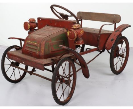 A pressed steel Tri-ang Dion Bouton child’s pedal car, English 1950s, metal seat with wooden back, metal spoked steering whee