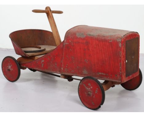 A pressed steel and wooden hand operated child’s car, French 1920s, wooden seat with steel lattice worked back, attached tin 