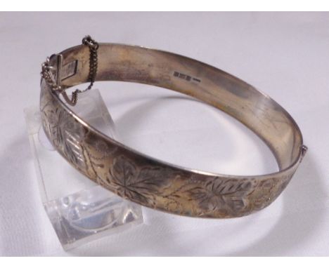 ANTIQUE SILVER BANGLE. Hallmarked antique silver bangle with engraving and safety chain