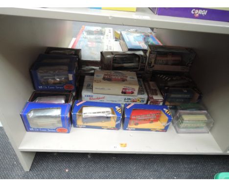 A shelf of modern Corgi, EFE diecasts, buses and trams, all boxed