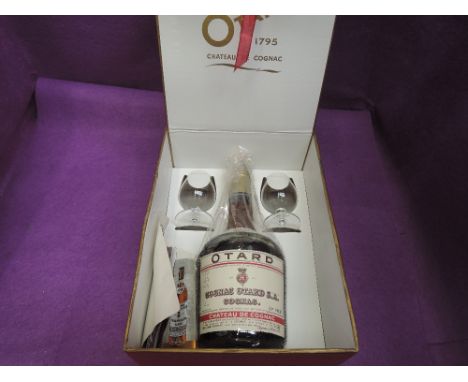 A bottle of 68% proof Otard V.S.O.P. Cognac in box with two Brandy balloon glasses