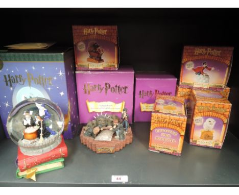 A shelf of Harry Potter collectables including Snow Globe, Secret Boxes etc, all boxed