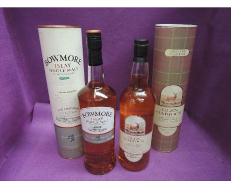 Two bottles of Scotch whisky, 1 litre of Glen Carioch Highland single malt in a card tube, 1 litre of Bowmore Islay single ma