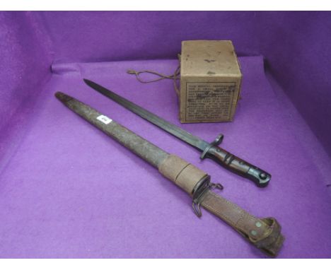 An Ameri can bayonet for American Enfield rifle model 1917 with scabbard, in very good condition, and a child's respirator in