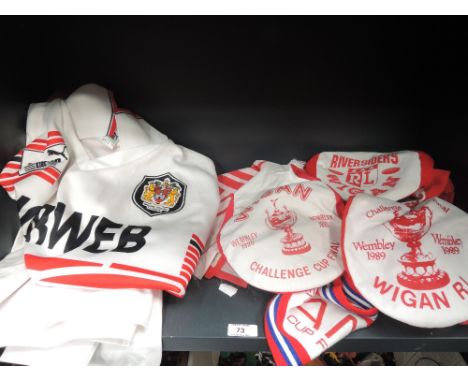 A shelf of 1980's and later Wigan Rugby League memorabilia including shirts, caps and scarves etc