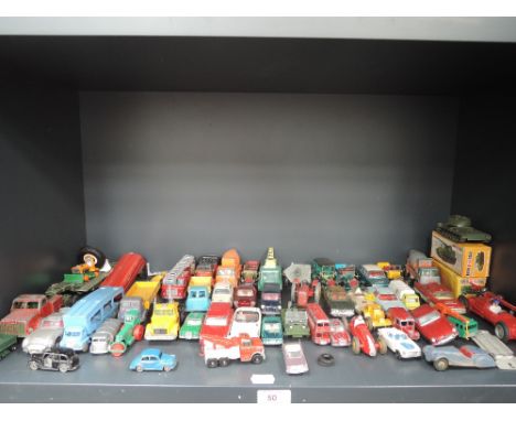 A shelf of playworn diecasts including Corgi, Matchbo, Lesney and similar