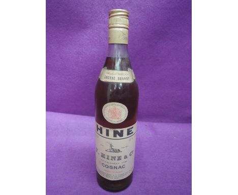 A bottle of specially selected Cognac Brandy Hine 70% proof 24 fl ozs, bottled by Thomas Hine &amp; Co snipped with the offic