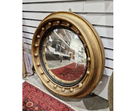 Early 20th century gilt framed convex wall mirror&nbsp;of circular form, adourned with gilt ball decoration, 63cm diameter ap