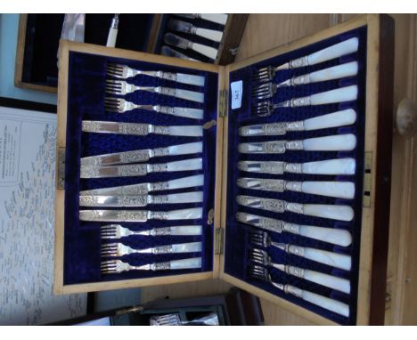 Pretty boxed canteen of dessert knives and forks, heavily engraved on mother of pearl handles 