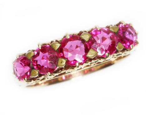 A five stone synthetic ruby ring, yellow metal band unmarked, size K/L.  Condition - appears to be gold plated, general wear.