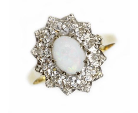 A hallmarked 18ct gold opal and diamond cluster ring, the oval cluster measuring approximately 12mm x 14mm, gross weight 4.8g
