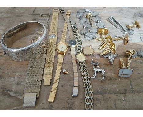 A mixed lot of jewellery and watches including a hallmarked silver and bright cut engraved bangle, gold plated watches, a nov