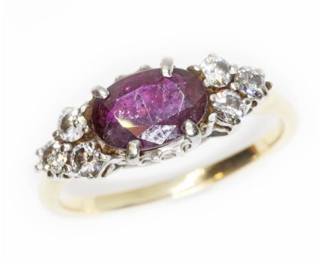 A ruby and diamond cluster ring, yellow metal band unmarked, gross weight 2.9g, size K.  Condition - evidence of glass fillin