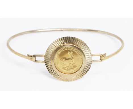 A 1981 1/10th Krugerrand bangle, partial hallmarks, Sheffield, diameter 5cm, gross weight 8.3g.
