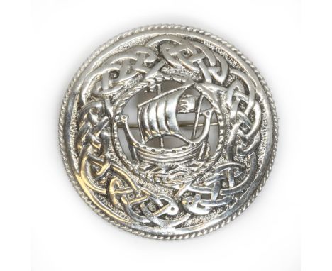 A Scottish silver brooch, of target/shield form with central viking longship and celtic design boarder, hallmarked; sponsor '