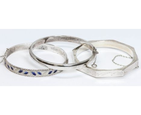 Two hallmarked silver hinged bangles and another marked '925', gross weight 38.6g.&nbsp;Condition - octagonal bangle with ver