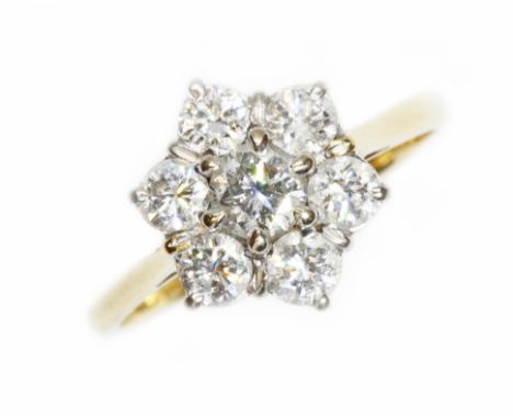 A seven stone diamond cluster ring, the round brilliant cut diamonds weighing approximately 1.50cts, white metal basket daisy