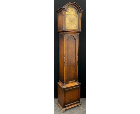 A George III style oak longcase clock, arch-topped hood, with hinged door to the brass dial, Roman numerals, chiming movement