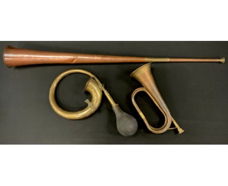 A copper and brass coaching horn, bearing label was used on the Dartmouth Stagecoach, 91cm long, 9.6cm diameter;  Boosey &amp
