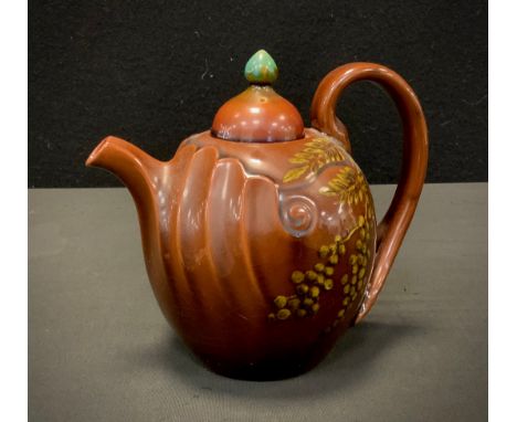 A Linthorpe Pottery shape 1246 tea pot, ovoid body, fluted moulding to the spout, bifurcated handle, decorated with slip glaz