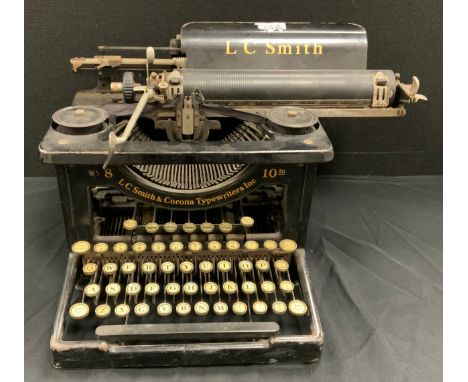 A 1920s/30s L C Smith and Corona typewriter and cover 