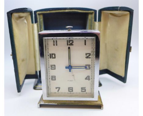 A Harrods Art Deco 8-Days travelling alarm clock in green leather case 
