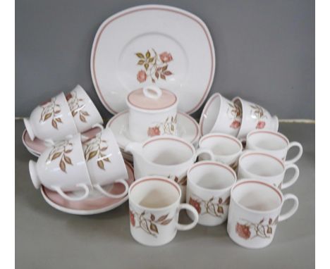 A Susie Cooper tea set comprising six tea cups and saucers, six coffee cups and saucers, milk jug, lidded sugar, six side pla