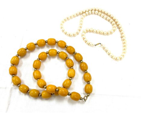 Cultured pearl necklace 9ct gold clasp and an art deco amber faturan type necklace