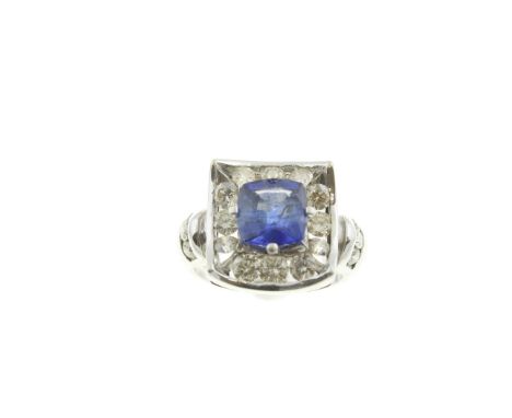 A sapphire &amp; diamond cluster ring, the cushion cut royal blue sapphire weighs approx 3.16cts, the round brilliant cut dia