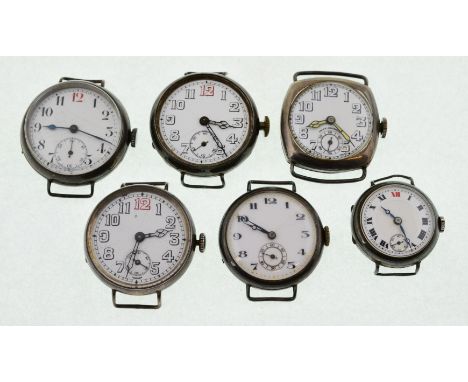 Six early 20th century silver watch heads, the whit enamel dials in overall good condition, three with light hairline fractur